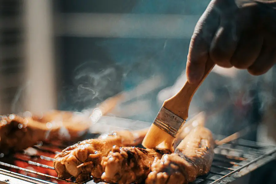 Close-up of grilled meat being prepared.