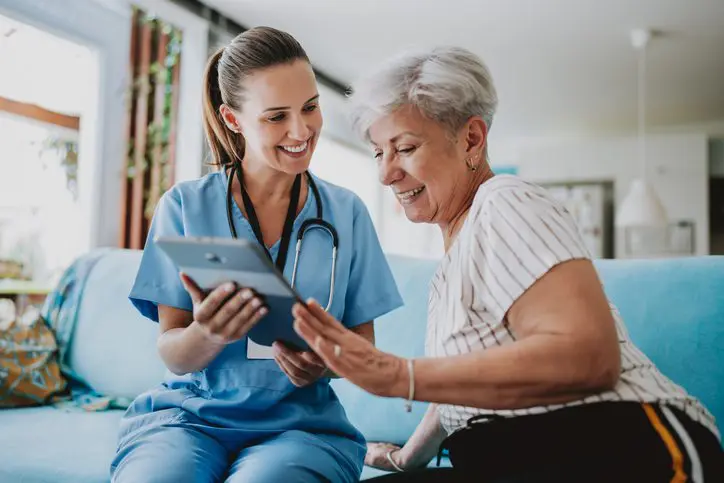 Home healthcare professional using tablet