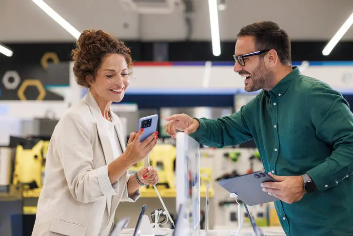 Man and woman discussing appliances in a store