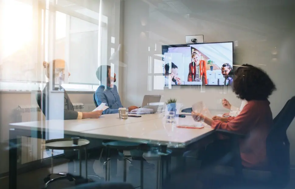 Corporate meeting room with hybrid conference setup.