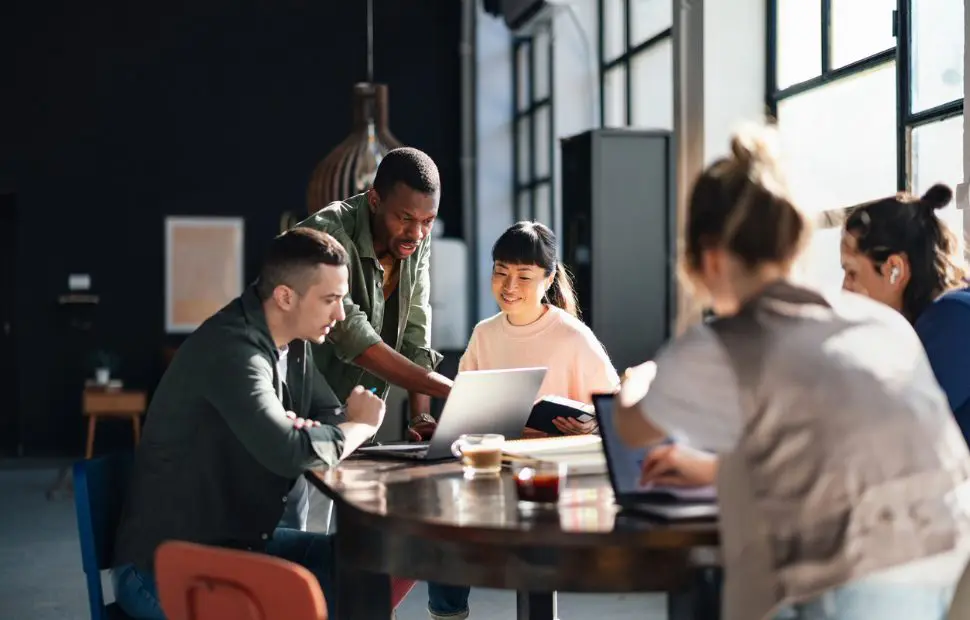 Diverse team collaborating around conference table.